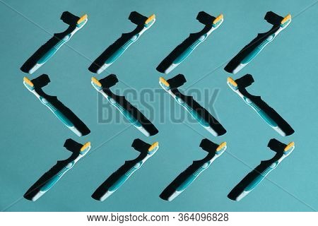 Plastic Toothbrushes On A Blue Pastel Background. Pattern