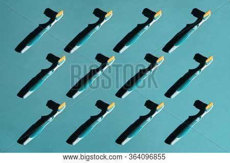 Plastic Toothbrushes On A Blue Pastel Background. Pattern