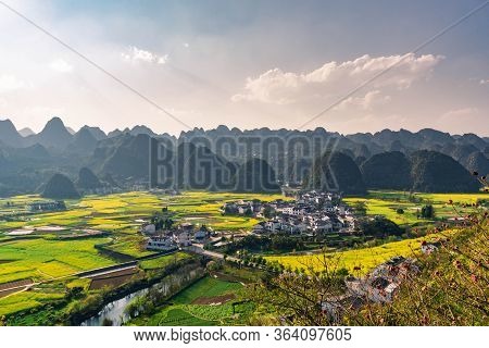 Rapeseed Flower Field And Villages At Wanfenglin  National Geological Park (forest Of Ten Thousands