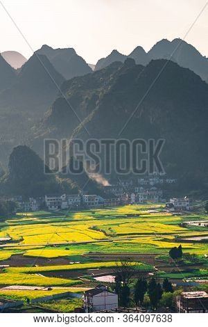 Rapeseed Flower Field And Villages At Wanfenglin  National Geological Park (forest Of Ten Thousands