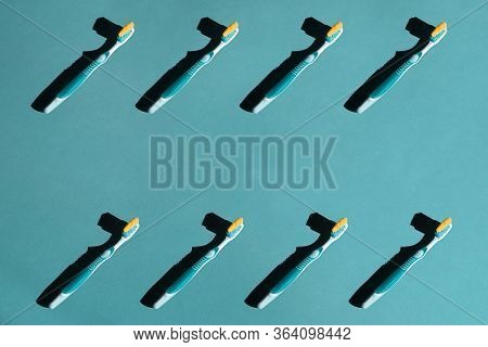 Plastic Toothbrushes On A Blue Pastel Background. Pattern