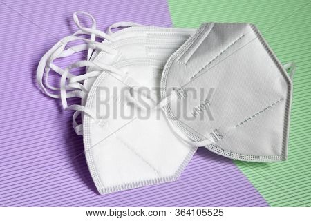 Closeup Of Antivirus Protection Masks Ffp2 Or Kn95 On Colored Background. Prevention For Coronavirus