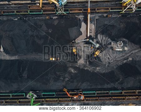 Loading Coal Anthracite Mining In Port On Cargo Tanker Ship With Crane Bucket Of Train. Aerial Top V