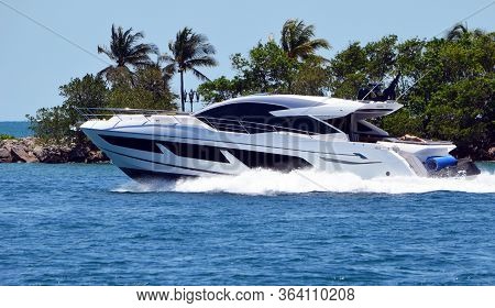 High-end Cabin Cruiser Speeding By Fisher Island On Government Cut Of Miami Beach,florida,