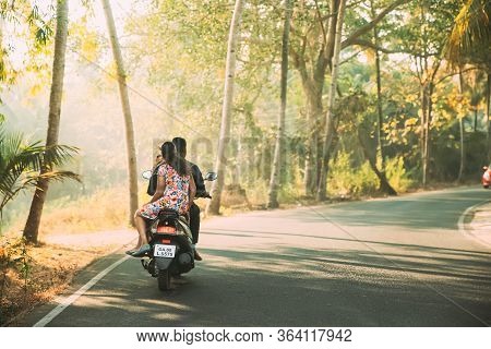 Margao, Goa, India - February 16, 2020: People Riding On Scooters Motorcycle On Road In Sunny Light.