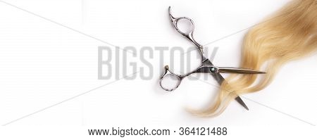 Hairdressers Scissors With Strand Of Blonde Hair, Isolated On White