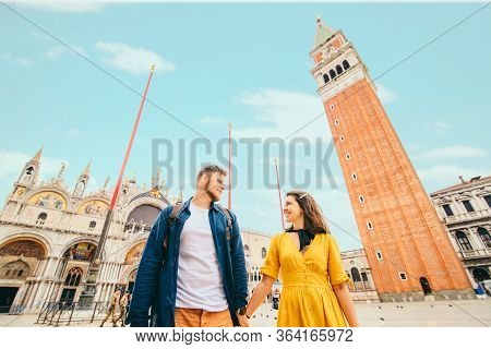 Couple Holding Hands At Saint Marks Square Venice Italy