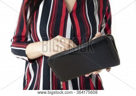 Young Stylish Woman Looking In A Wallet. Close-up On Hands With A Wallet