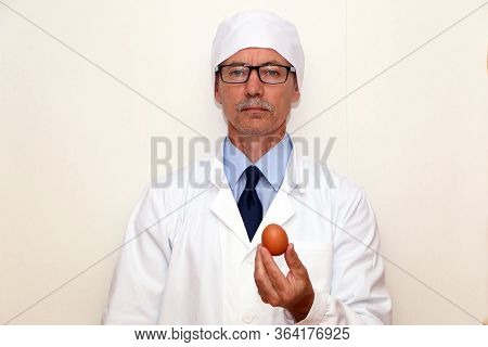 The Doctor Holds In His Hands A Dietary Egg For Proper Wholesome Nutrition.