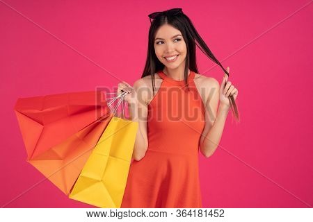 Image Of A Beautiful Excited Happy Asian Woman Posing Isolated Over Pink Wall Background Holding Sho