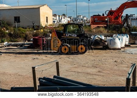 Torrevieja, Valenciana, Spain - May 02 2020 : Mini Jcb Digger In Builders Yard On Urbanisation In Sp