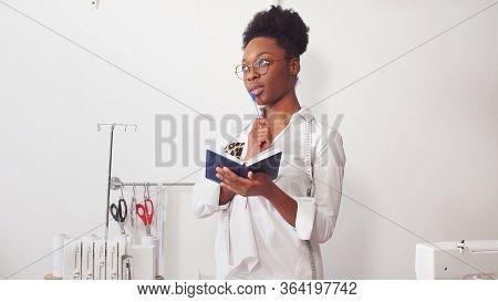 African Seamstress, Fashion Designer Working With Fabric, Seamstresss Workplace In The Workshop.
