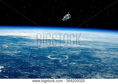 Astronaut In Space, In Zero Gravity Near The Planet Earth. Astronaut In Orbit In Free Flight, Planet