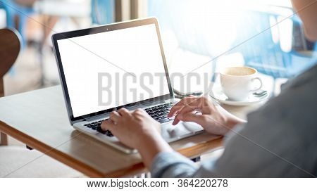 Asian Freelance Man Using Laptop Computer Working In The Cafe. Businessman In Casual Clothing Doing 