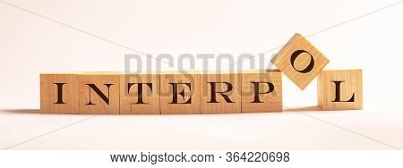 Interpol - Word Written On Wooden Cubes On A Light Background