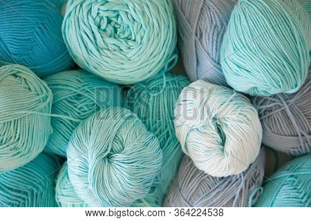 Colored Balls And Skiens Of Yarn. Top View. Aquamarine Colors. Yarn For Knitting.