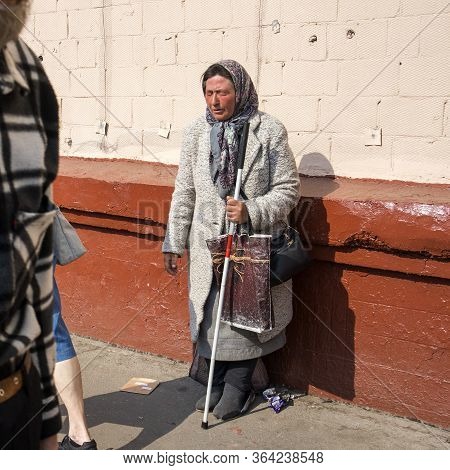 Moscow, Russia - 1st Of May, 2019, A Woman With Sealed Eyes, Pretending To Be Blind, With A Stick In