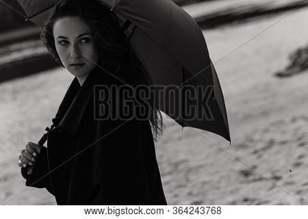 Woman In The Coat With Umbrella In Her Hands
