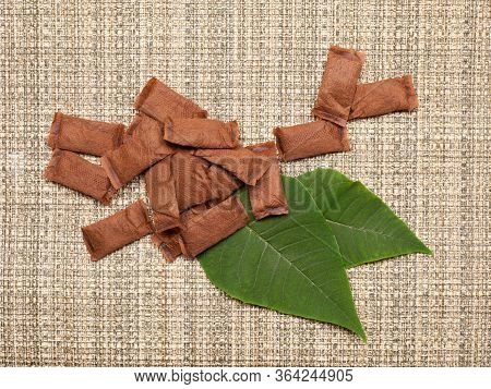 Pouches Of Smokeless Tobacco On Rough Rustic Background. Top View
