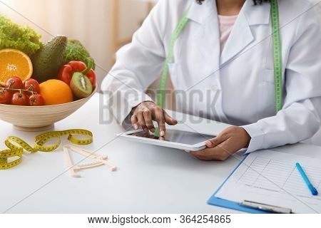 Cropped Of Dietologist Black Woman Working With Digital Tablet At Clinic