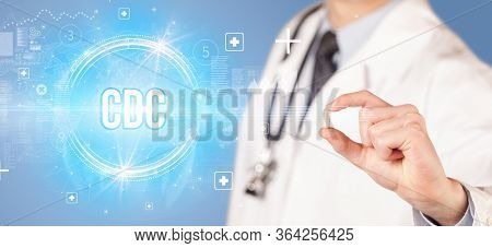 Close-up of a doctor giving you a pill with CDC abbreviation, virology concept