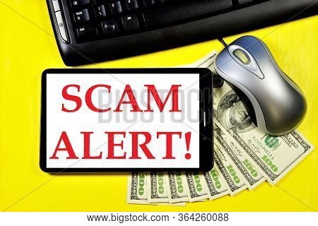 Scam Alert-a Message On The Tablet Computer Screen. Fraud Is Theft Or Acquisition Of The Right To An