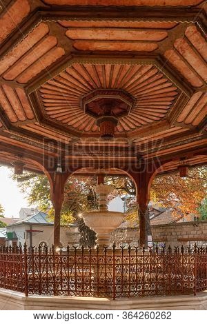 Beautiful fountain Sadrvan located in the courtyard of Gazi Husrev Begova Mosque with an ornate wooden ceiling in Sarajevo, Bosnia and Herzegovina
