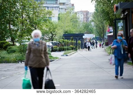 Kyiv, Ukraine, 02.05.2020: The Photo Without Focus. Art Priyy. People Coming From Shops Wearing Medi