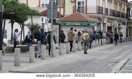 Crowd Of People Queuing Outside Bank On Restricted Opening Day
