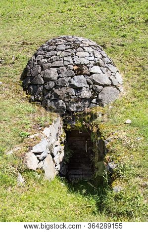 The Traditional Stone Cave Celler Crotti With Entrance Door, In Brusio, Canton Graubuenden, Switzerl