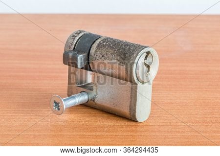 Cylinder Lock Internal Mechanism On Wooden Table.