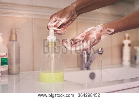 Washing Of Hands With Soap Under Running Water. An African-american Woman Washes Her Hands. Press On