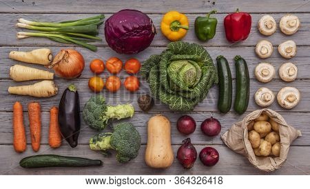 Layflat Composition Of Fresh Vegetables Arranged On A Wooden Background
