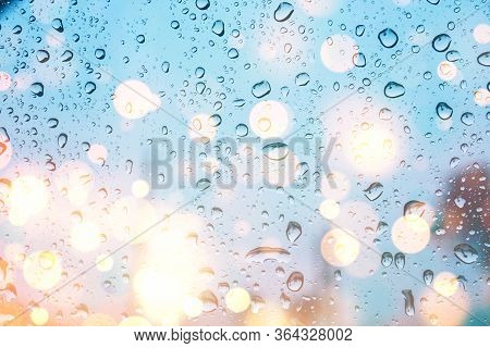 Water Drops On Glass Window With Bokeh Lights