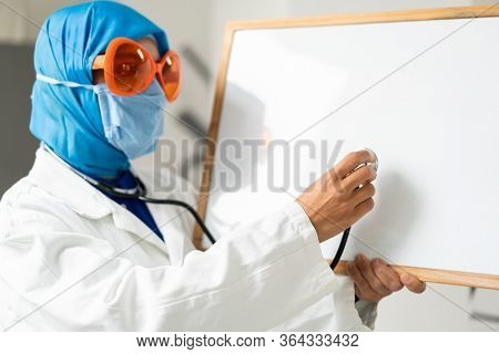 Muslim female doctor with blank whiteboard