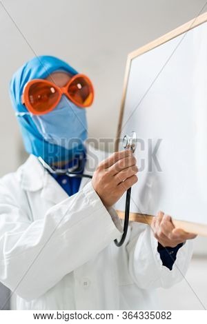 Muslim female doctor with blank whiteboard