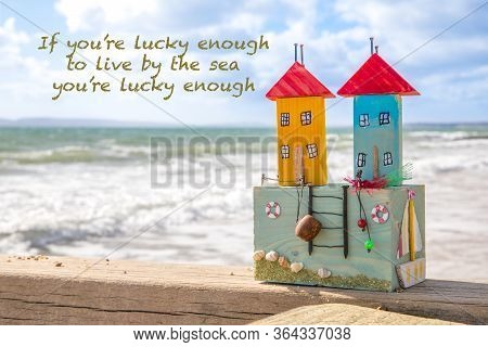 Southbourne Beach, Dorset, England. Crafted Wooden Harbor Cottages Sitting On A Groyne With A Seasca