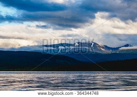 Spectacular View Of A Mountain Range In Clouds Near A Lake In Ulagansky District Of The Altai Republ