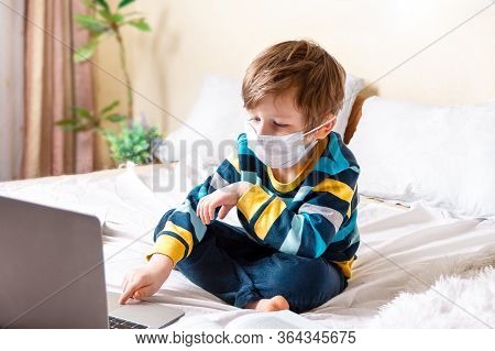 Distance Learning Online Education. Sickness Boy In Medical Mask Studying Home With Laptop Notebook 