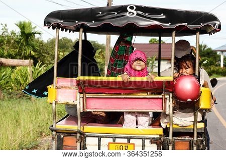 Ko Lanta, Thailand - Aug. 17, 2011: Kids Riding In Traditional Tuk Tuk At Ko Lanta Island, Thailand,