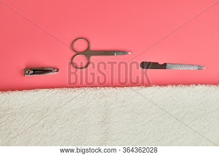 Manicure Tools With White Towel On Pink Background