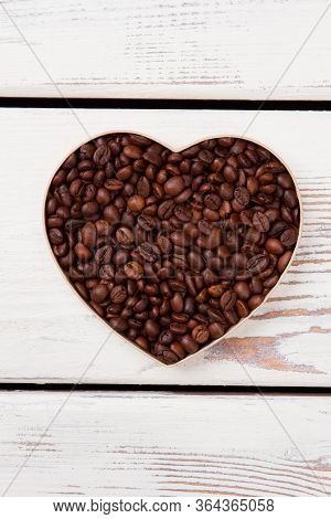 Coffee Heart Shape On White Wood. Brown Roasted Beans.