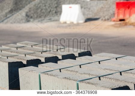 Piled Concrete Curbstones. Construction Material For Road Construction Works. Construction Backgroun