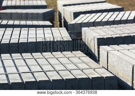 Piled Concrete Curbstones. Construction Material For Road Construction Works. Construction Backgroun