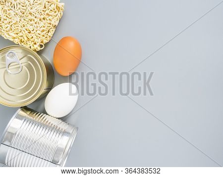 Tin Cans, Macaroni, Eggs On A Gray Background, Copispace, Mock Up. Stocks Of Fast Food And Long-term