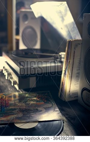 The Vinyl Disc Lies On A Table Near The Vinyl Player, Amplifier And Accustics. Old School Turntable.