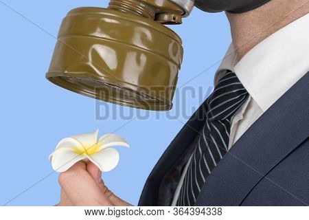 Close Up Portrait Of Man In A Protective Gas Mask With Flower