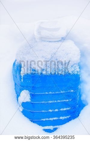 Non-freezing Liquid For Washing Car Glass In Winter. Winter Car Wash Glass Liquid In The Snow. Car N