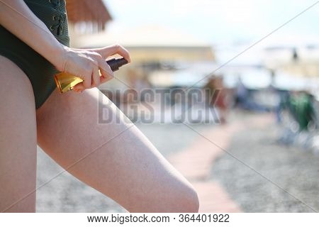 Sunscreen Spray Applying Spf Concept. Sunscreen Suntan Lotion In Spray Bottle. Young Woman In Sprayi