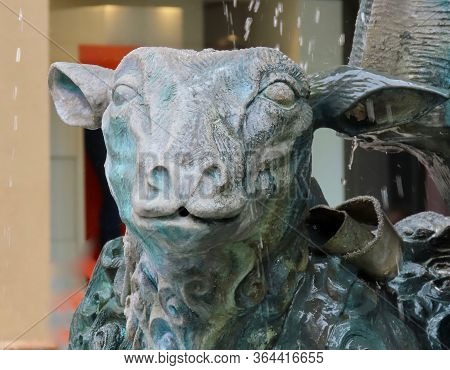 Luxembourg, Luxembourg - August 8, 2019. Close Up Of A Sheep Face From Green Copper Sculpture With D